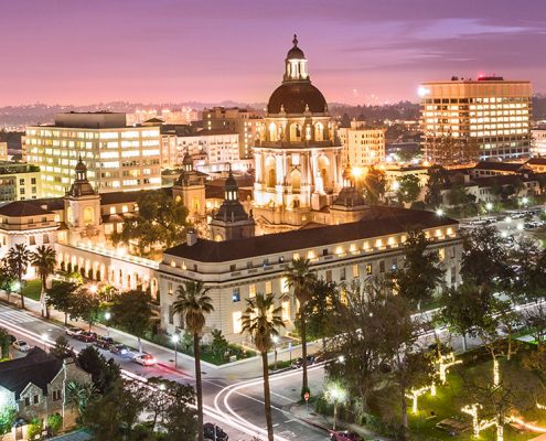 Pasadena City Hall and surrounding buildings illuminated at dusk.